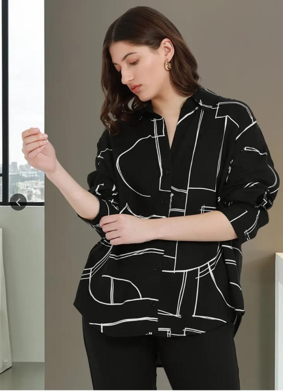 Black button-up shirt with white abstract geometric line pattern, featuring long sleeves and a loose fit